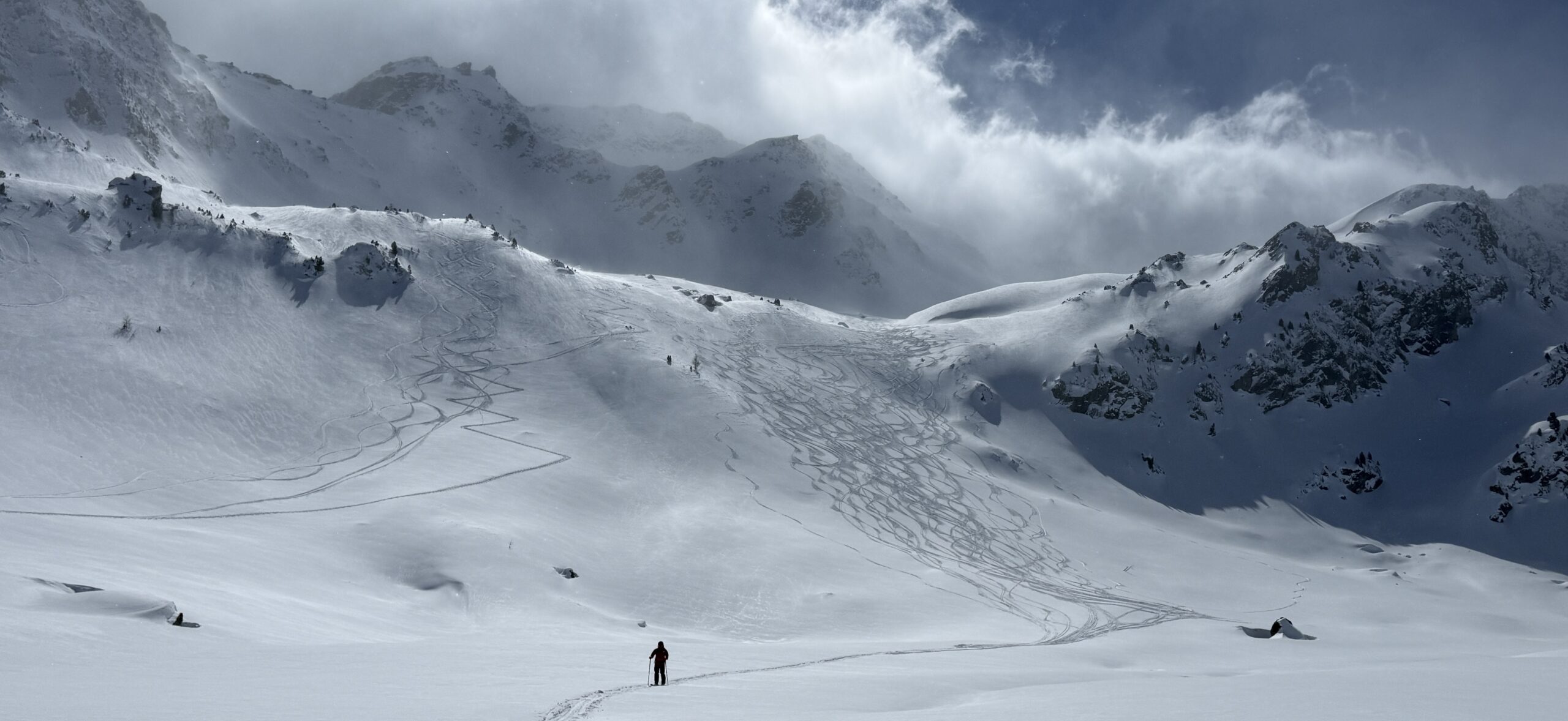 Skier descending unpatrolled off-piste terrain
